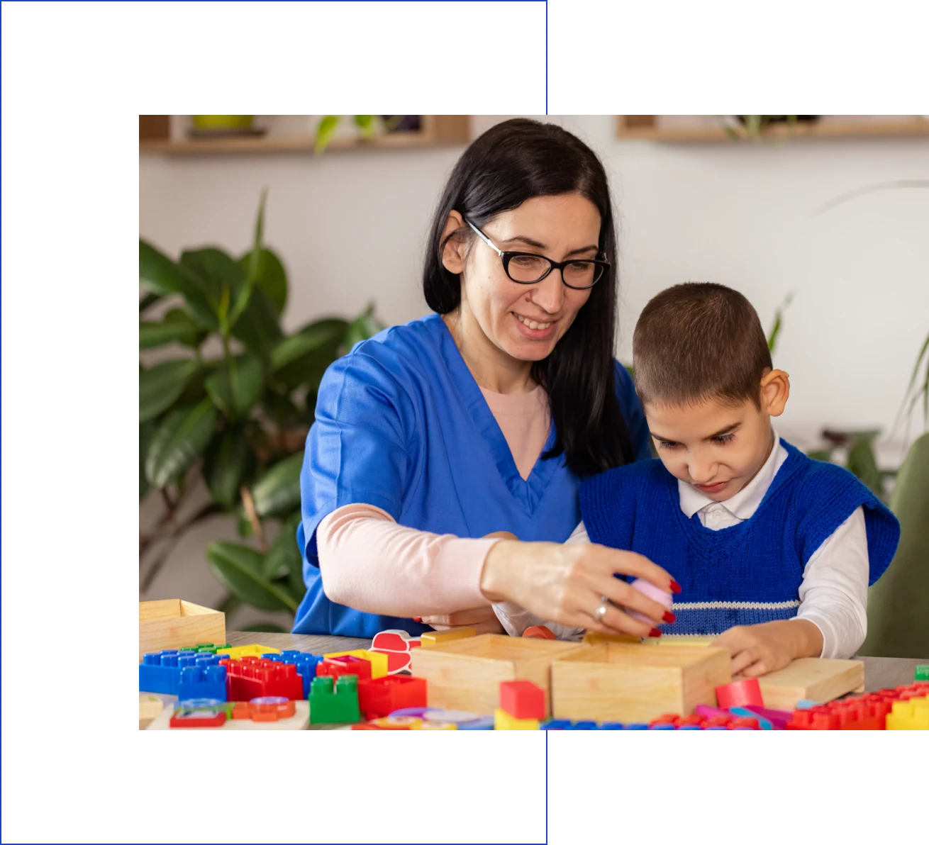 Teacher and child playing with blocks.