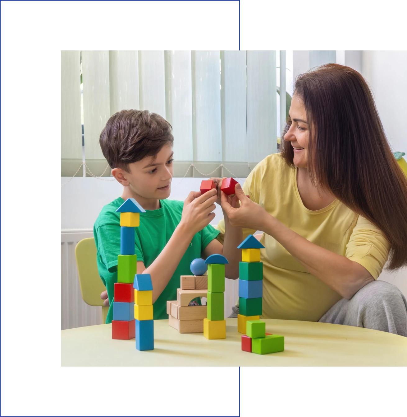 Child and woman playing with colorful blocks.
